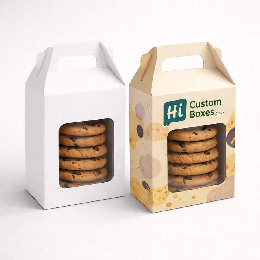 Two tall cardboard boxes with handles and clear windows- filled with stacked chocolate chip cookies- class=
